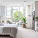 London studio flat interior, compact open-plan layout, neutral-toned carpeted floor